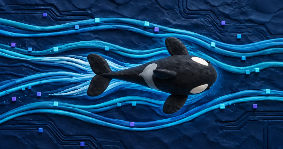 A handmade clay orca seen from above, swimming through cyan clay currents and tiny data tiles over a navy ocean with circuit grooves.